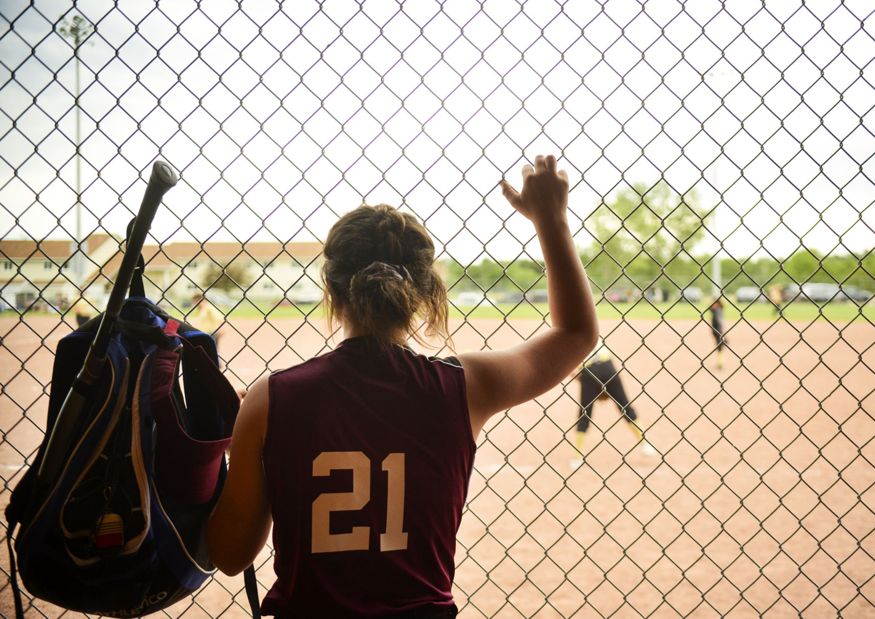 Cooper Harness watches the Sheridan pitcher warm up